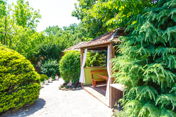 Wooden Gazebos in a summer cafe in the spring. Spring greenery and trees around