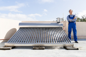 Worker Standing Near Solar Energy Boiler