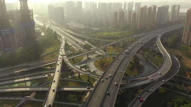 flight over sunset time light hangzhou traffic street road interchange cityscape construction aerial panorama 4k china