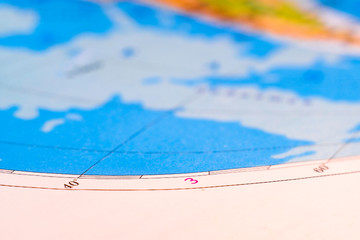 closeup image of degrees of latitude and longitude in an atlas
