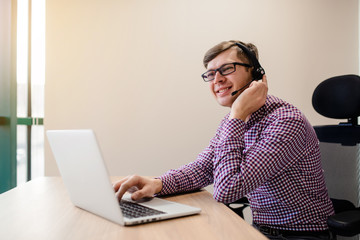 Young handsome man with casual shirt and glasses, happy businessman