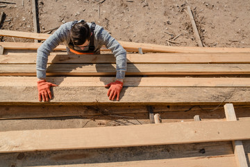 Top view of young man carpenter at the wooden warehouse
