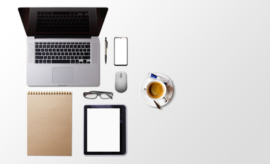 Modern workspace with coffee cup, smartphone, paper, notebook, tablet and laptop copy space on white color background. Top view. Flat lay style.