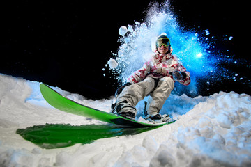Man in winter clothes glides on a snowboard