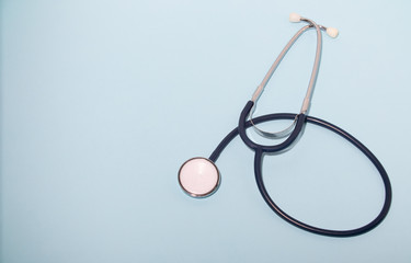 Medical stethoscope or phonendoscope  isolated on light blue background. Close-up of a stethoscope. flat lay. your text here