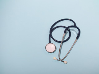 Medical stethoscope or phonendoscope  isolated on light blue background. Close-up of a stethoscope....