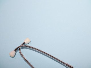 Medical stethoscope or phonendoscope  isolated on light blue background. Close-up of a stethoscope....