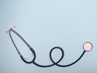 Medical stethoscope or phonendoscope  isolated on light blue background. Close-up of a stethoscope....