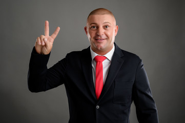Businessman showing peace sign