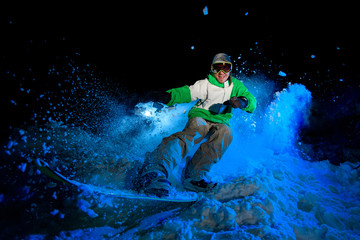 Guy in green jacket rides on a snowboard