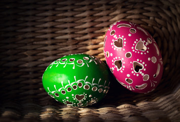 Color Easter eggs on knitted basket