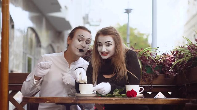 Two happy mime on a date in the cafe. Romantic date