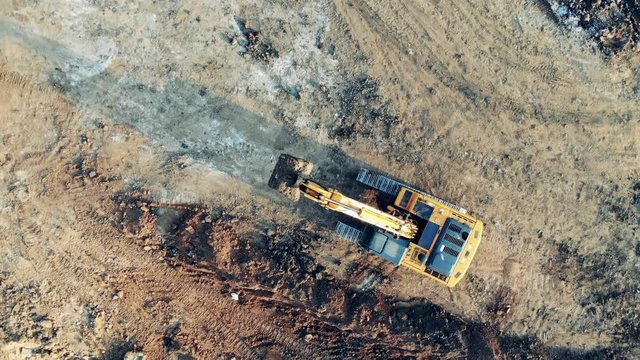 Shoveling machine is riding along the extraction ground