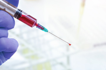 close-up syringe and blood sample inside