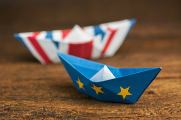 paper ships from the flags of the European Union and the UK - international relations between...