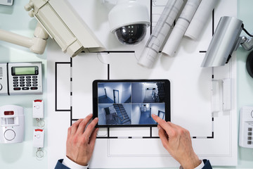 Person Watching Footage On Digital Tablet