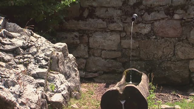 Natural spring of drinking water in a wooden trough. Wooden trough with clean, fresh, natural water source