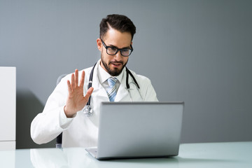 Doctor Having Video Conference On Laptop