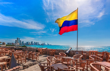 Street cafe in colonial Cartagena Walled City (Cuidad Amurrallada) overlooking scenic shoreline of Bocagrande and hotel zone - obrazy, fototapety, plakaty