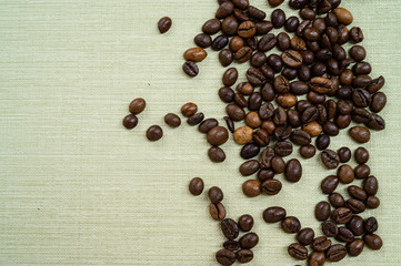 Coffee beans isolated on background with space for text. Roasted coffee beans as background. Flat lay, top view, copy space