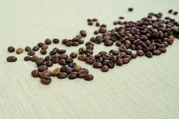 Fototapeta na wymiar Coffee beans isolated on background with space for text. Roasted coffee beans as background. Flat lay, top view, copy space