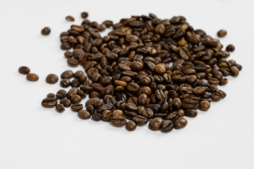 Coffee beans isolated on white background background with space for text. Roasted coffee beans as background. Flat lay, top view, copy space. Close up