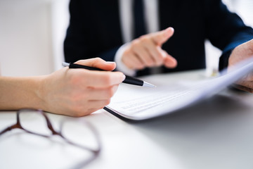 Two Businesspeople Analyzing Document