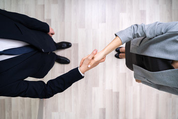 Businessmen Shaking Hands In Office
