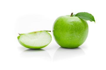 Ripe green apple with leaf on a white background .