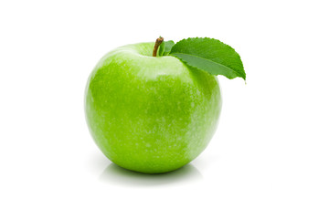 Ripe green apple with leaf on a white background .