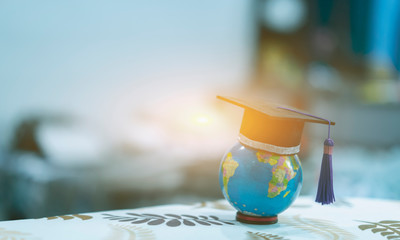 Education study abroad in Global world,Back to School and Graduation cap on student hand holding Earth globe map,Success of Global business study abroad educational,congratulation Graduation Ceremony