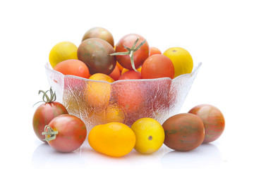 Cherry tomatoes in glass bowl isolated on white