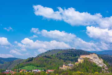 Fototapeta na wymiar orava castle of slovakia. medieval fortress on a hill in a beautiful place in mountains. wonderful sunny weather with fluffy clouds in springtime