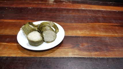 Traditional Malay food known as 'lemang' on timber surface