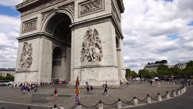 Low angle aerial view. Arc de Triomphe. Famous tourist attractions in Paris. Historic landmark. Romantic honeymoon travel destination in France. 
