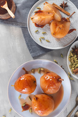 Poached pears delicious home made recipe over light kitchen countertop. Top view. Flat lay