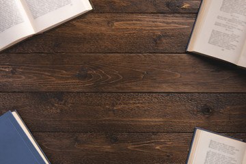 Books isolated on wooden background. Flat lay, top view, copy space.