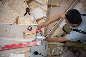 carpenter installing wooden stairs