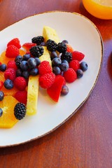 A healthy fruit plate with pineapple and berries