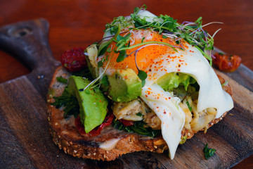 Multigrain avocado toast with fried egg on top