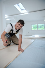 Professional Worker Installing New Laminated Wooden Floor