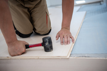 Professional Worker Installing New Laminated Wooden Floor