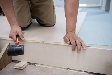 Professional Worker Installing New Laminated Wooden Floor