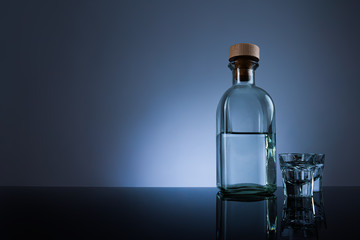  Premium looking bottle of Vodka, with two glasses, on a black background, studio photo, copy space 
