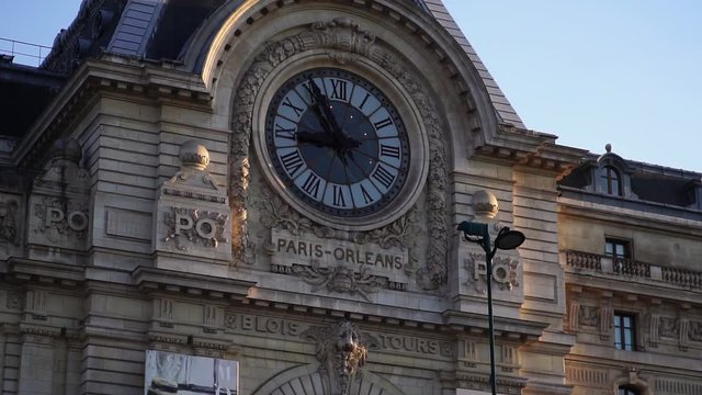 Historic clock on building facade. Mus&eacute;e d'Orsay. Glide shot. Paris tourism attraction & famous landmark. Romantic honeymoon travel destination