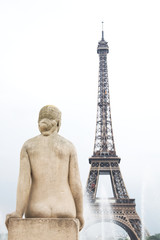 Fototapeta na wymiar Statue of woman with Eiffel tower and the fountain in Paris, France