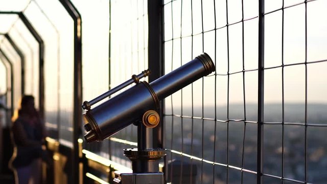 Eiffel tower telescope binoculars, view of Paris cityscape. Romantic honeymoon travel destination and famous tourism landmark in Paris, France. 
