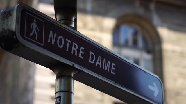 Notre Dame street sign in Paris. Tourism attraction & famous landmark in France. Romantic honeymoon travel destination.