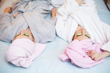 Fototapeta na wymiar Two pretty girls doing facial spa treatments