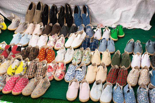 Shoes handmade shop for sale travelers people buy at street market in Bangkok, Thailand